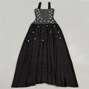 Detailed view of elegant black evening gown with white lattice and rhinestone patterns