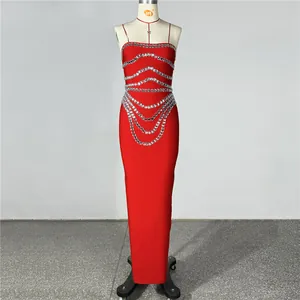 Detailed view of red bandage dress featuring intricate silver rhinestone patterns.