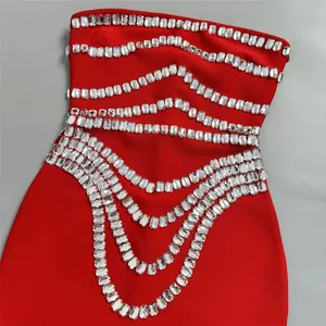 Close-up of luxury red bandage dress featuring heavy rhinestone embellishments