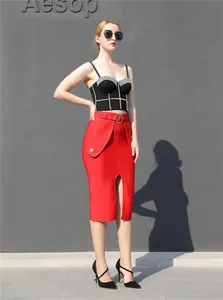 Detailed view of red high-waisted slit bandage skirt and black rhinestone bustier set.