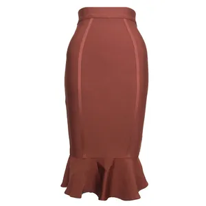 Macro view showing the ruffle fishtail hem and textured bandage fabric of the rust brown skirt