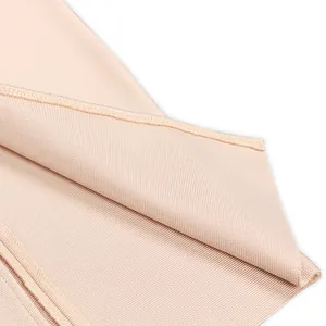 Close-up detail of high-quality nude bandage dress fabric showing elastic texture