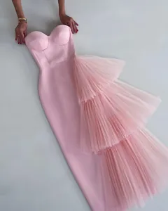 Elegant pink strapless bodycon evening gown featuring tiered tulle ruffle side detail