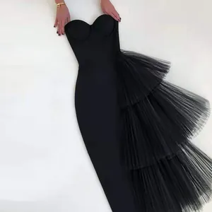 Detail of black strapless bandage dress with elegant tiered mesh ruffle design.