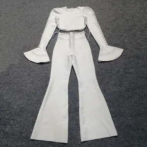 Elegant white two-piece bandage set with flared pants and hollow-out lace sleeves