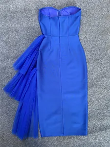 Back detail of royal blue strapless bandage dress with tiered tulle ruffles.