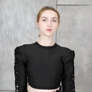 Close-up of black bandage crop top with hollow-out lace puff sleeves and crew neck
