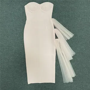 Detail view of pink strapless bodycon dress with cascading layered mesh tulle design