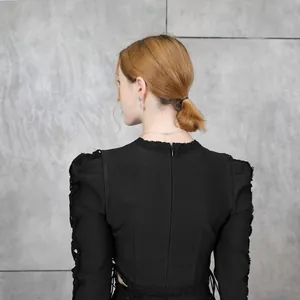Detail of black long-sleeve bandage top featuring back zipper and hollow-out waist.