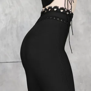Detail view of black bandage skirt featuring waist lace detailing and a hip-hugging fit.