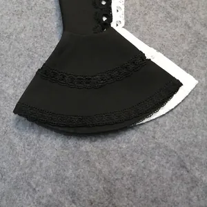 Close-up detail of a black flared bell sleeve featuring elegant multi-layered lace trim