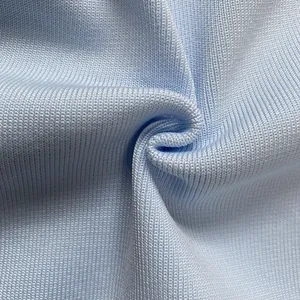 Close-up detail of light blue ribbed bandage dress fabric showing soft texture and knit
