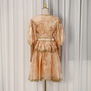 Detailed back view of a French court style puff sleeve midi dress with golden floral print