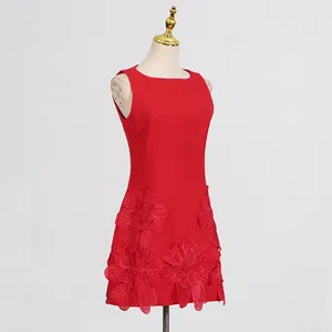 Red sleeveless dress featuring intricate 3D floral appliqués at the bottom hem