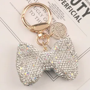 Close-up of sparkling rhinestone bow keychain with elegant gold-tone hardware