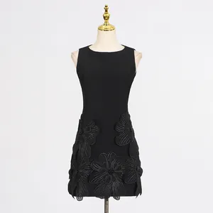 Detailed view of the elegant black sleeveless dress with large 3D flower appliques