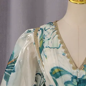 Close-up view of the elegant V-neck and golden lace trim on a floral puff sleeve dress