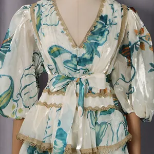 Close-up of V-neck lace trim and floral print on French style puff sleeve dress.