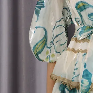 Detailed view of the puff sleeve and gold lace trim on a floral French court style dress
