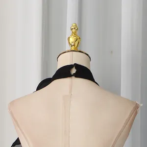 Detail view of the back button closure on a black halter neck evening dress.