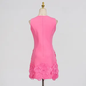 Detail showing the back of a pink sleeveless dress with intricate 3D floral applique