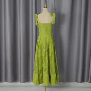 Rear view of green sleeveless maxi dress with detailed 3D floral embroidery and bow straps