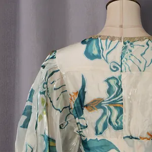 Detailed view of French style floral midi dress featuring puff sleeves and lace patchwork