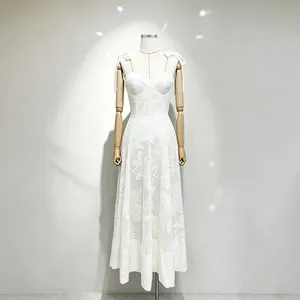 Detailed view of a white floral embroidered dress with sweetheart neckline and bow straps.