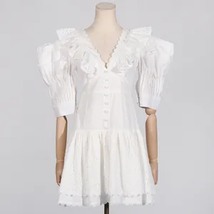 Elegant white French V-neck dress with puff sleeves and heavy embroidery details.