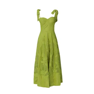 Detailed view of the vibrant green embroidered floral pattern on a tie-strap midi dress.