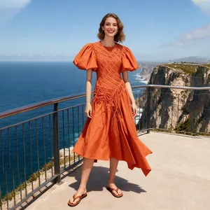 Detail of vibrant orange puff sleeve dress with ruched bodice and asymmetrical hemline