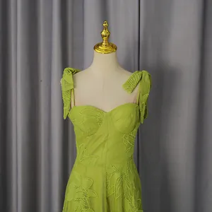 Detail view of the lime green dopamine color strap dress with floral embroidery