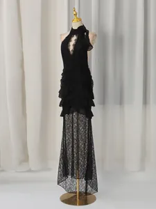 Elegant black lace halter neck evening dress with deep V-cut and ruffled fishtail hemline