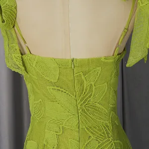 Close-up back detail of green lace slip dress with leaf embroidery and hidden zipper.
