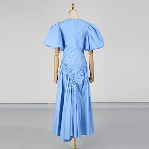 Vista posteriore dettagliata di un abito blu plissettato stile francese con maniche a sbuffo