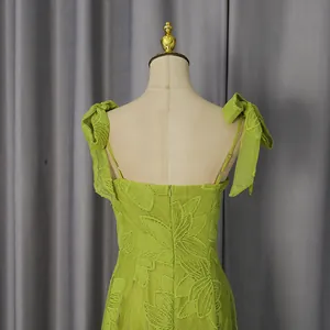 Detail back view of lime green embroidered maxi dress featuring elegant shoulder bows
