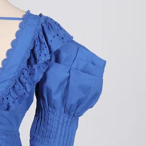 Detail showing ruffled eyelet lace and pleated puff sleeves on blue French dress