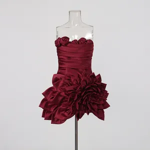 Close-up of a burgundy strapless mini dress with intricate 3D floral petal details