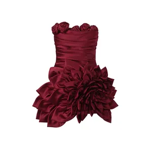 Detail of a burgundy strapless mini dress featuring intricate 3D floral petals and ruching.