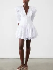 White French style eyelet dress with ruffled V-neck and puff sleeves detail