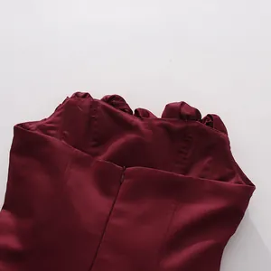 Close-up of wine red strapless dress back with invisible zipper and floral trim