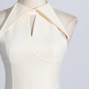 Detailed view of white French style dress featuring a unique lapel and neckline cutout