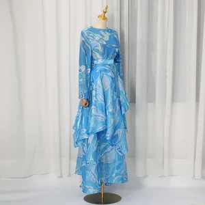 Detail view of a retro blue patterned satin two-piece set with an irregular maxi skirt