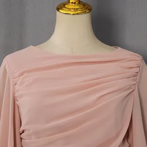 Detailopname van de elegante geplooide roze chiffonstof van een luxe lange avondjurk