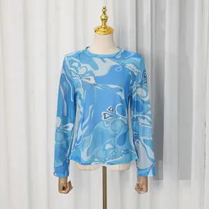 Elegant blue abstract floral print long sleeve mesh top displayed on a mannequin stand