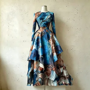 Full view of retro satin long-sleeve top and printed asymmetrical skirt on mannequin