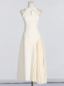 French style sleeveless midi dress with lapel collar and asymmetrical pleated skirt.