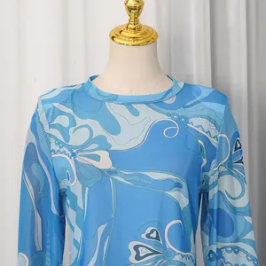 Close-up detail of blue abstract vintage floral print on round neck long sleeve top