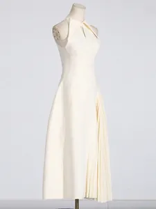French style sleeveless pleated dress with lapel and cutout waist design.