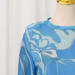 Detailed close-up of retro blue floral print mesh long sleeve top with round neck